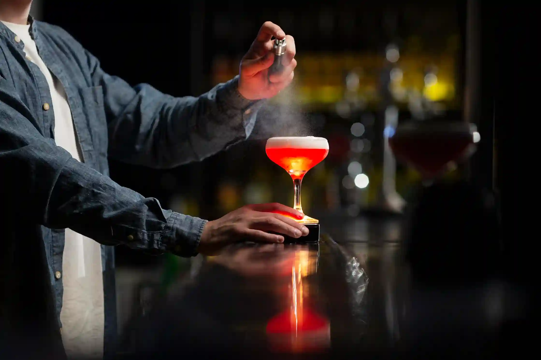 "Bartender pouring a craft cocktail from a shaker at the AW Mobile Bar